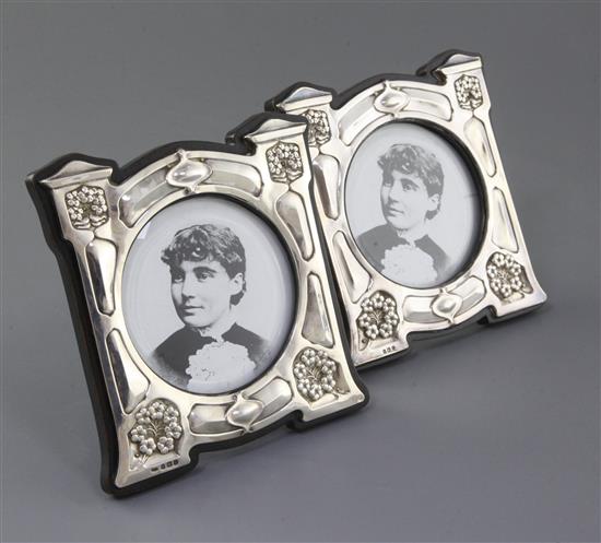 A pair of Edwardian Art Nouveau shaped silver mounted photograph frames by J. Aitken & Son, height 15.7cm.